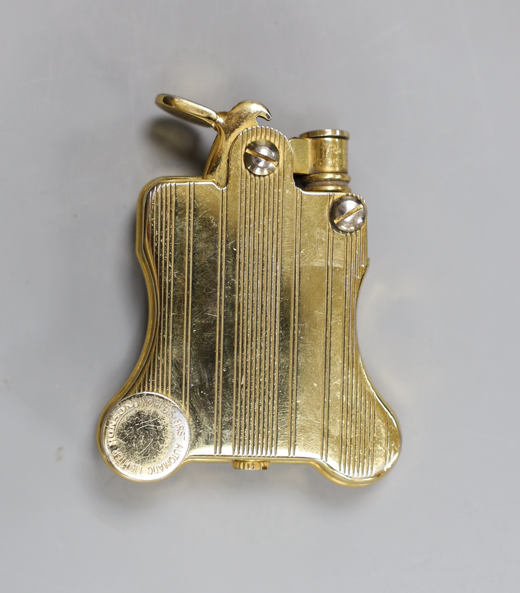 A Russian enamelled and seed pearl set brooch initialled KAOT, 1.75cm, gross 2.5 grams and a gold plated Ronson automatic cigarette lighter